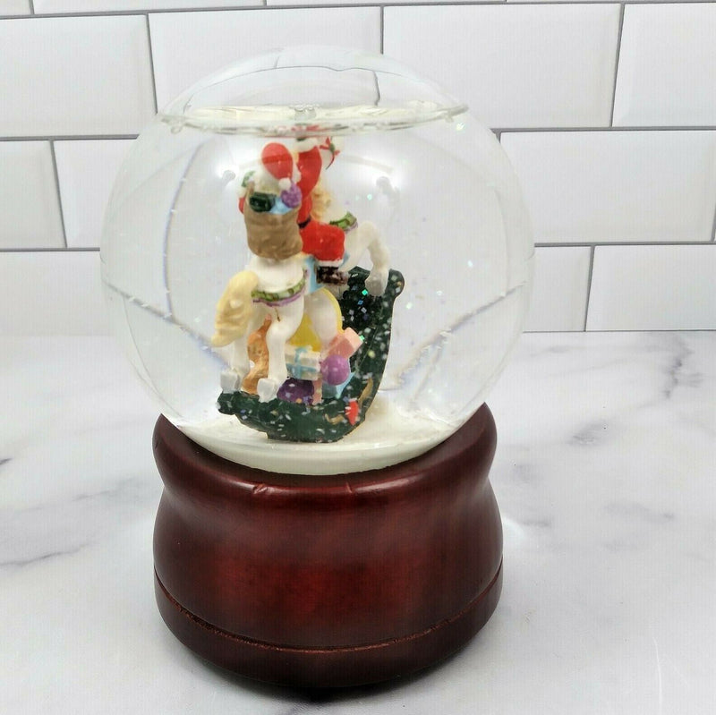 Load image into Gallery viewer, Santa on Rocking Horse Animated Music Box Snow Globe