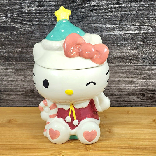 Hello Kitty figurine with a Christmas hat on a wooden surface
